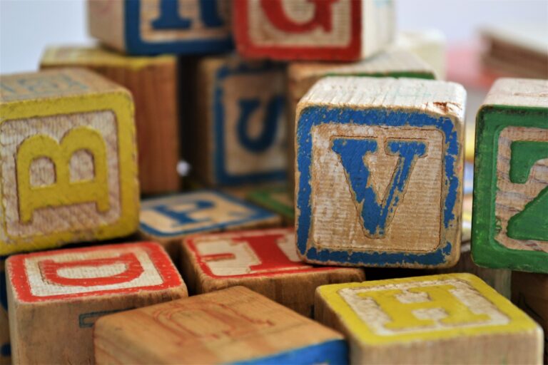 a pile of worn kid's toy letter blocks